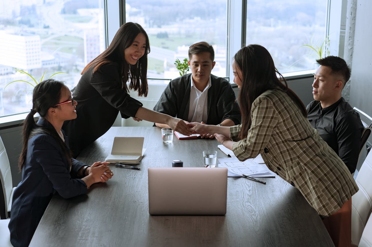 A diverse group of professionals collaborating in an office meeting, fostering teamwork and innovation.